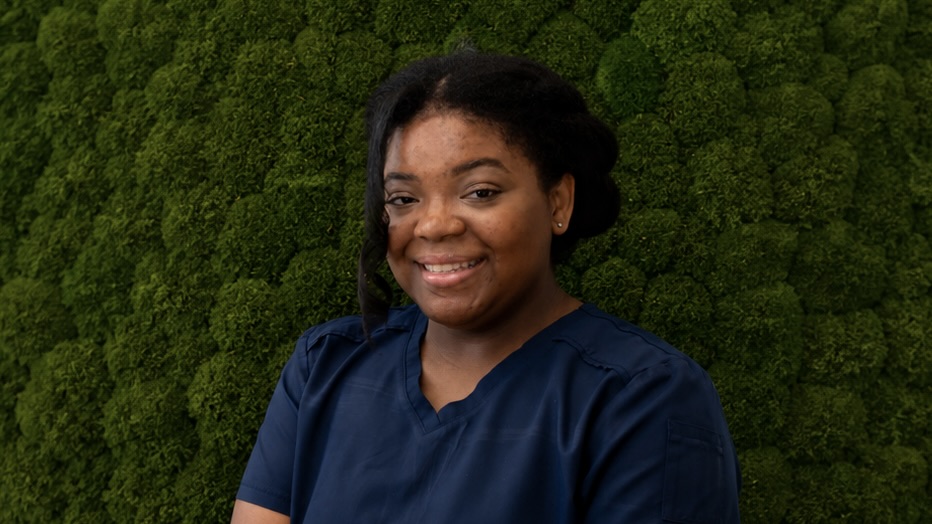 Woman in front of green background