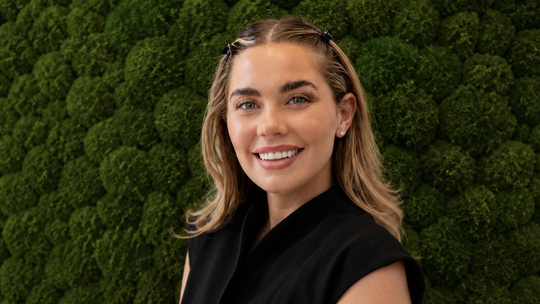 blonde Woman in front of green background