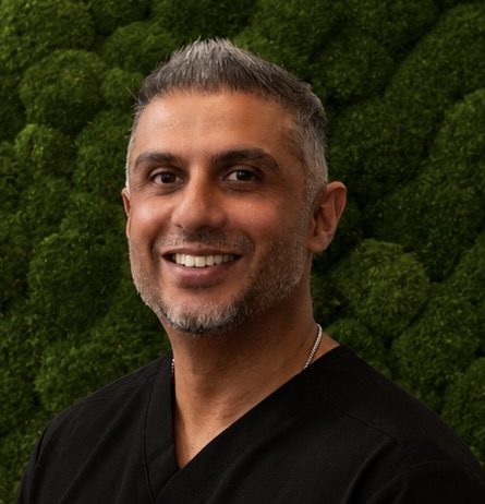 man in front of green background