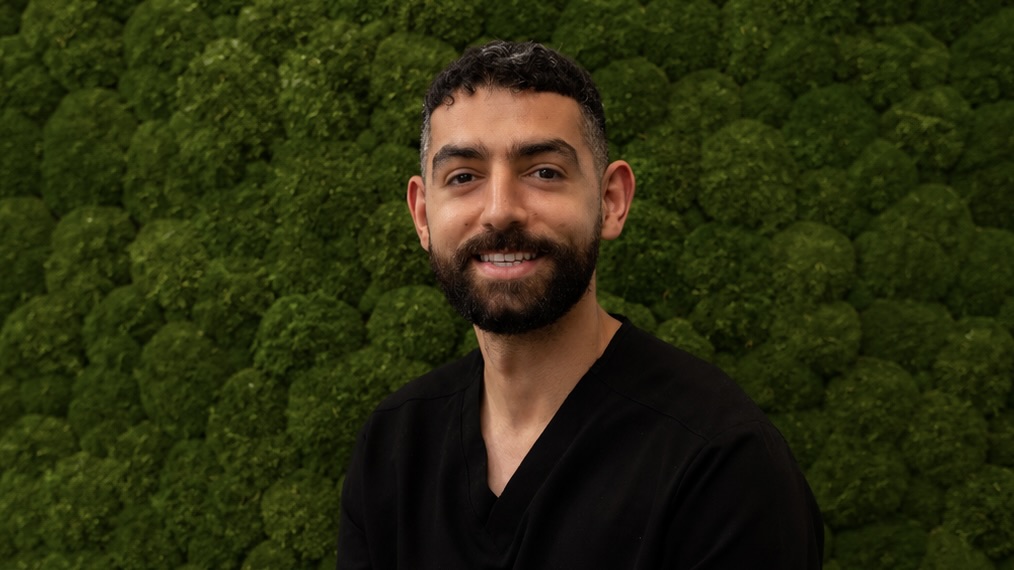 man in front of green background