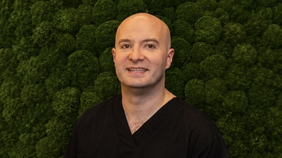 man in front of green background
