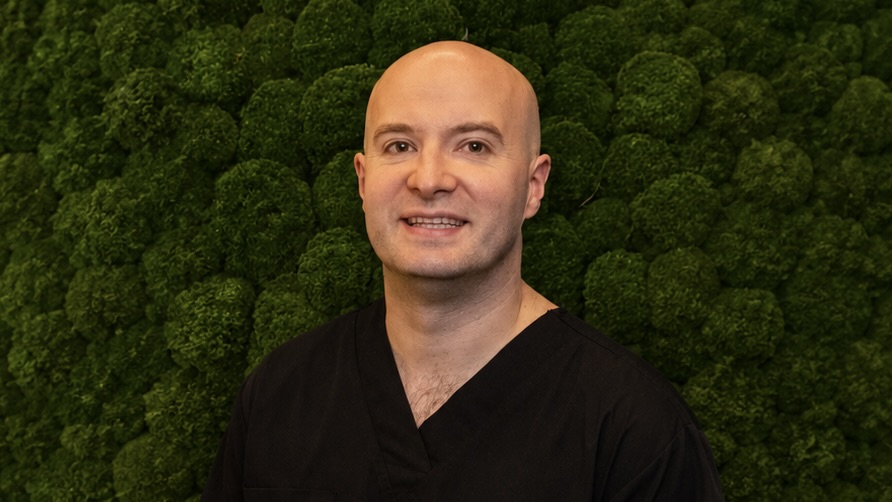 man in front of green background