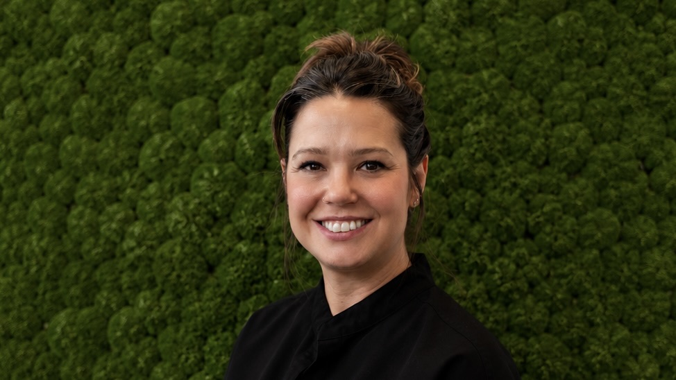 Woman in front of green background