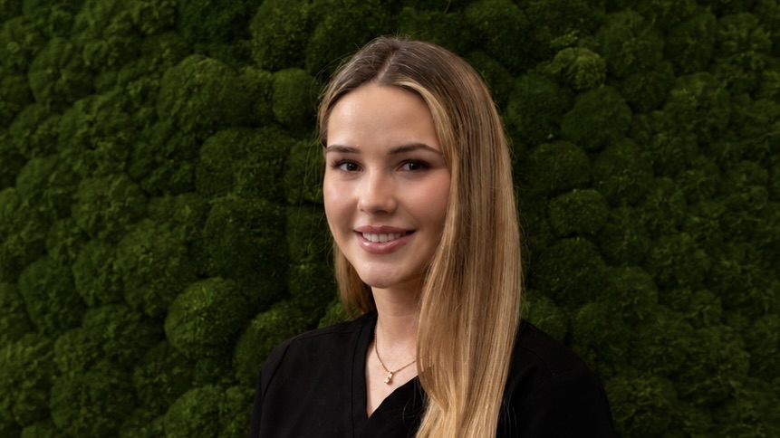 Woman in front of green background