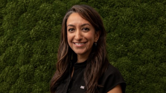 Woman in front of green background