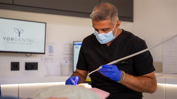 Hitesh Panchal performing a procedure on a patient