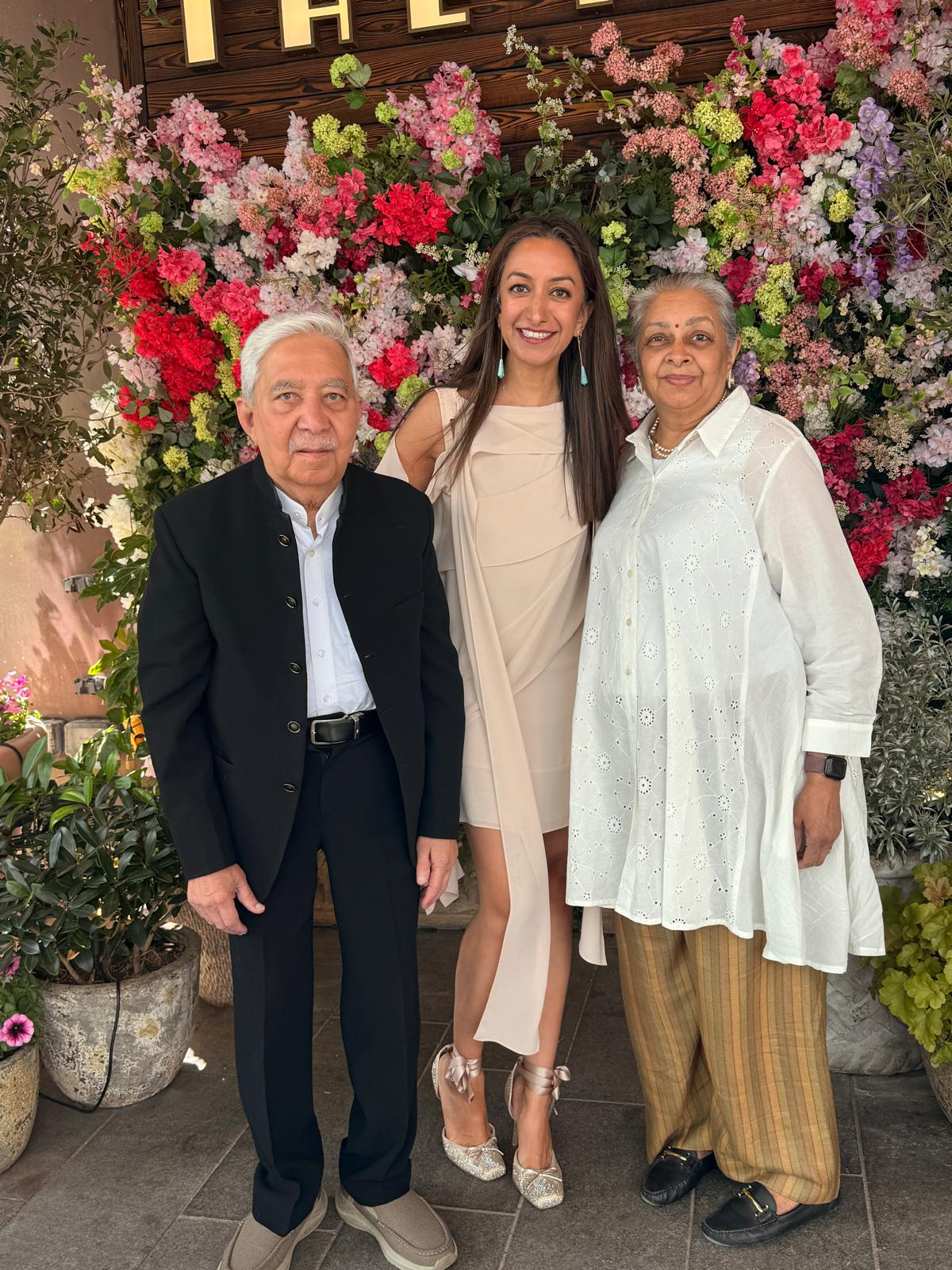 A woman with her father on her left and her mother on her right