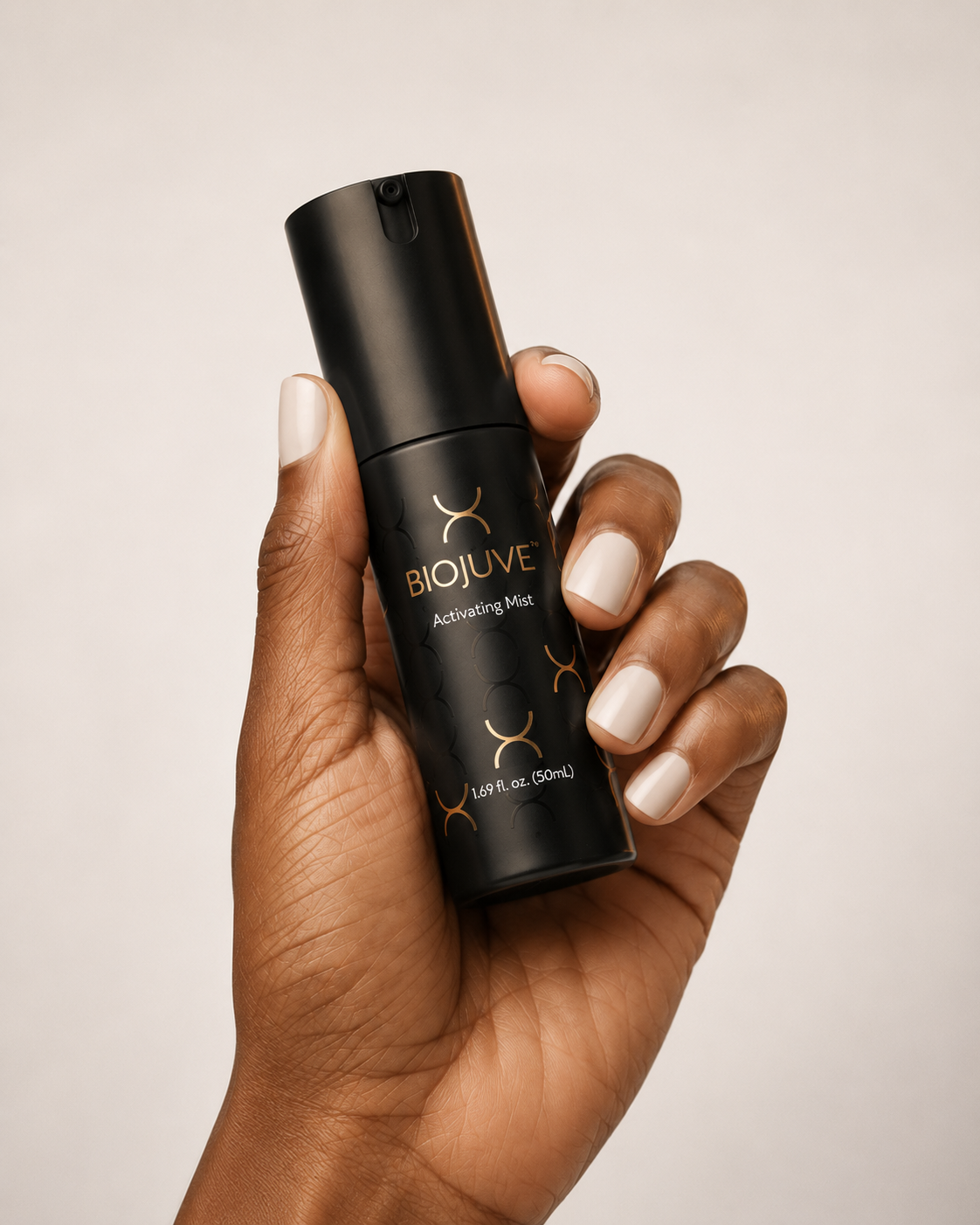 Person holding the 'biojuve activating mist' product