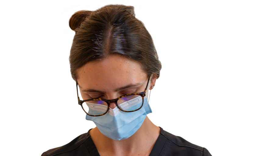 Transparent of dentist actively working on a client as they lay horizontal
