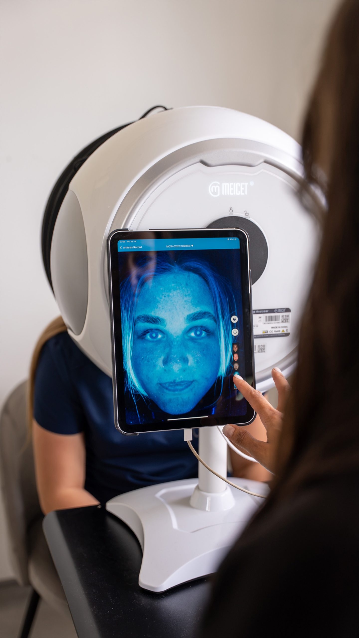 dentist inspects digital scan of female patient's face