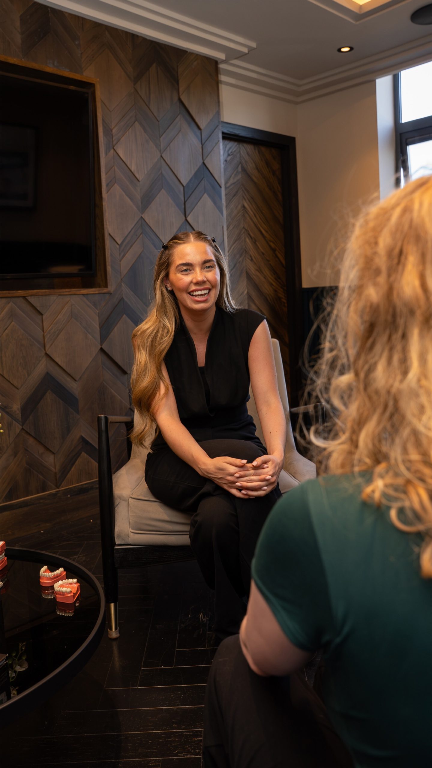 Dentist having a consultation with a patient as she smiles